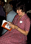 Photograph of a woman reading Behind the Chalet School
