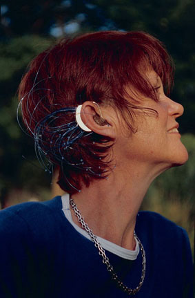 Photo of Ali Briggs wearing her hearing aid jewellery