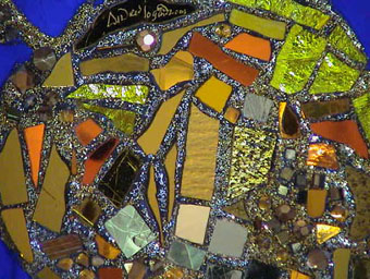 Close up of mirror mosaic on front of exhibit with Andrew Logan's signature