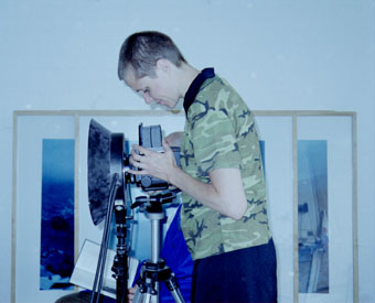 Photo of Melanie Manchot looking into her camer lens