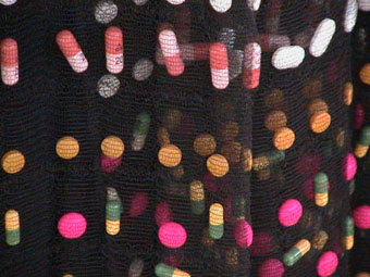 Close up of pills woven into the material