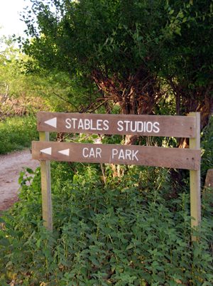 Colour photograph of the sign to the Stables Studios and the car park
