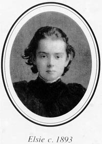 Black and white photographic portrait of the head and shoulders of a young girl