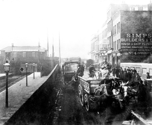 Black and white photograph of men driving horse drawn carts