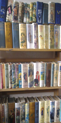 Colour photograph of shelves containing Oxenham's books