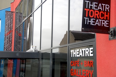 Colour photograph of the outside of the Torch, with a sea gull admiring its reflection in the window