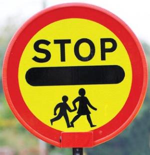 Colour photograph of a stop, children crossing sign
