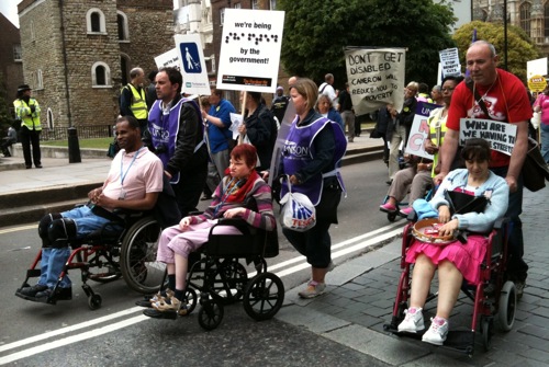 Colour photograph of disabled people protesting against the cuts